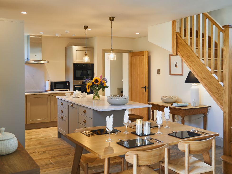 A kitchen with dining area and staircase at The Reading Rooms in Oughtershaw near Buckden