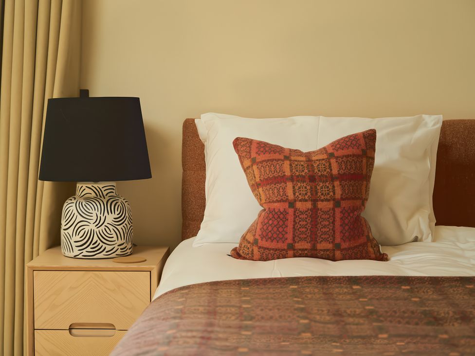A bedroom with a bed and lamp at The Reading Rooms Oughtershaw near Buckden