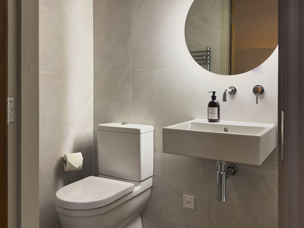 A bathroom with a toilet and sink at The Reading Rooms in Oughtershaw near Buckden