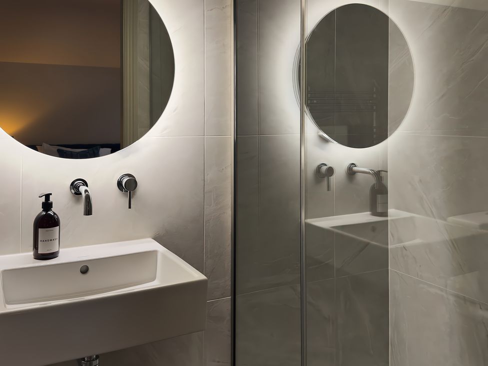 A bathroom with a sink and mirror at The Reading Rooms in Oughtershaw near Buckden