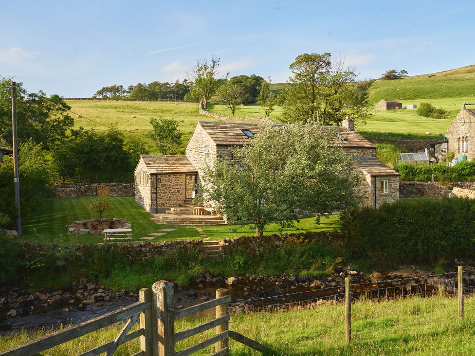 A house with a garden and a river at The Reading Rooms in Oughtershaw near Buckden