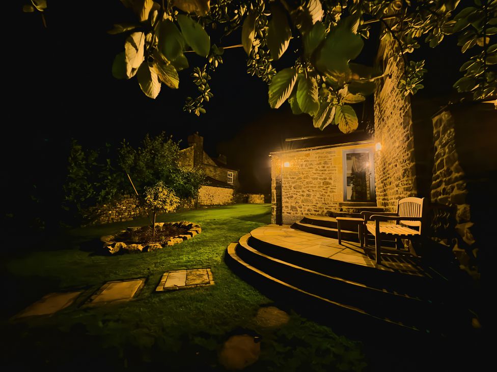 A garden with steps and a chair at The Reading Rooms in Oughtershaw near Buckden