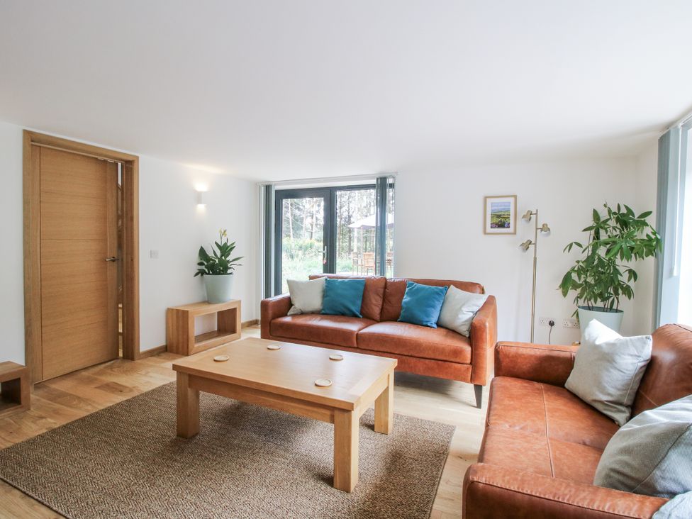 A living room with a sofa and table at The Barn in Acton near Bishop's Castle