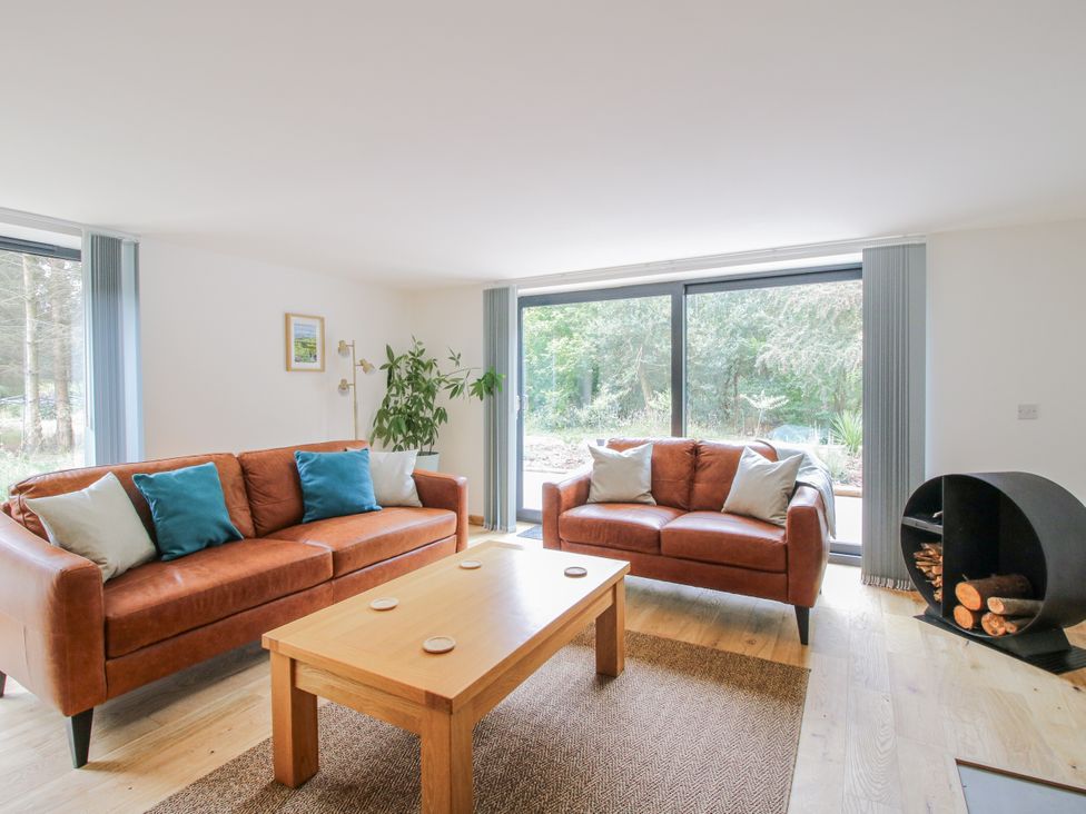 A living room with sofas and a table at The Barn in Acton near Bishop's Castle