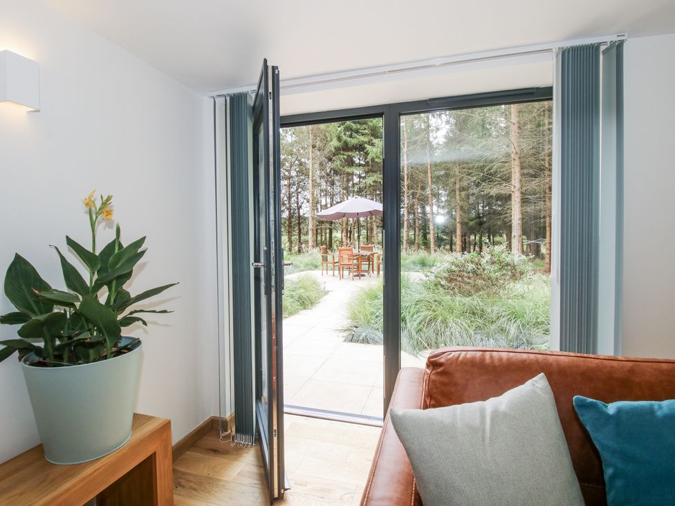A living room with a view of an outdoor seating area at The Barn in Acton near Bishop's Castle