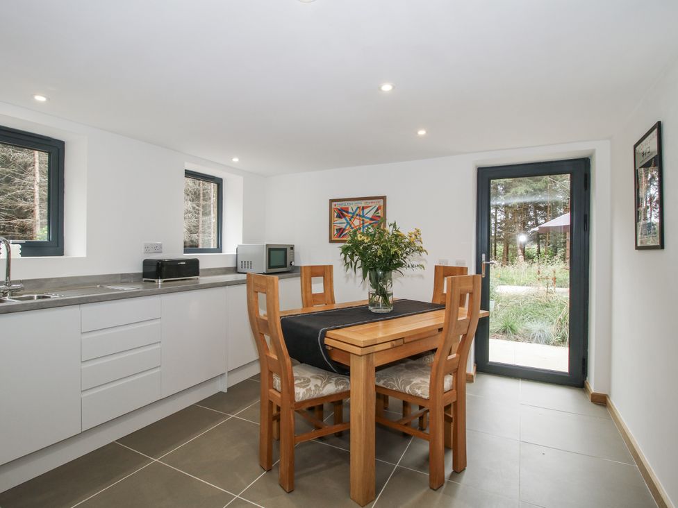 A kitchen with a table and chairs at The Barn in Acton near Bishop's Castle