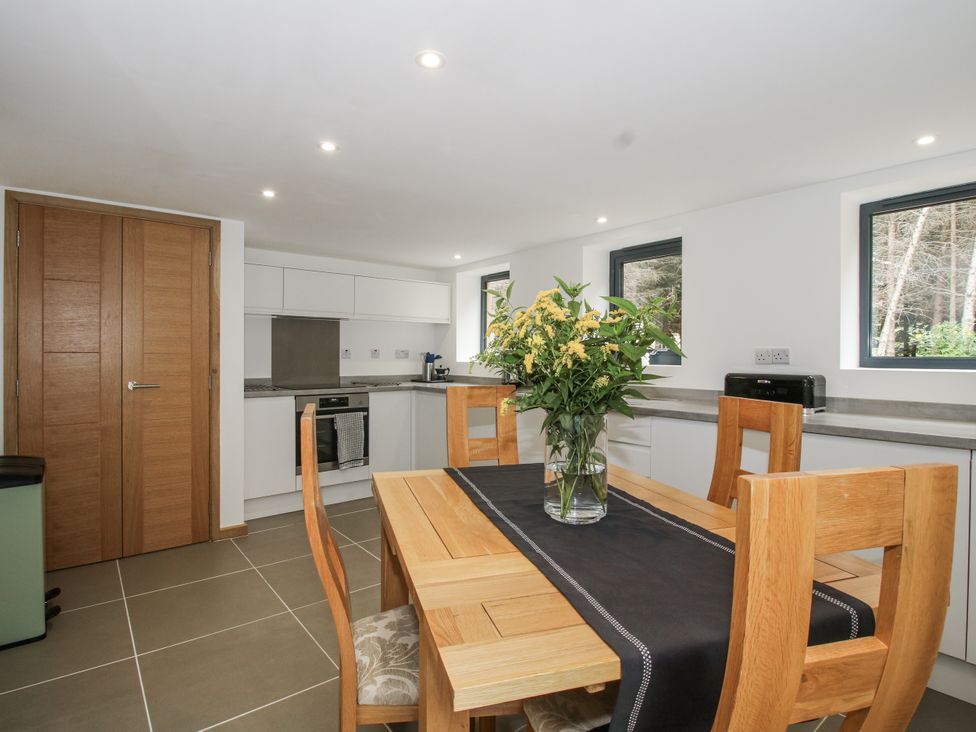 A kitchen with a table and chairs at The Barn in Acton near Bishop's Castle