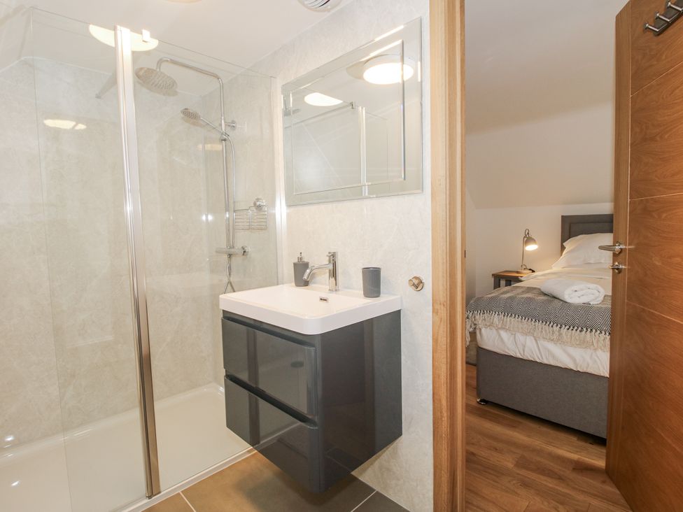 A bathroom with a shower and sink at The Barn in Acton near Bishop's Castle
