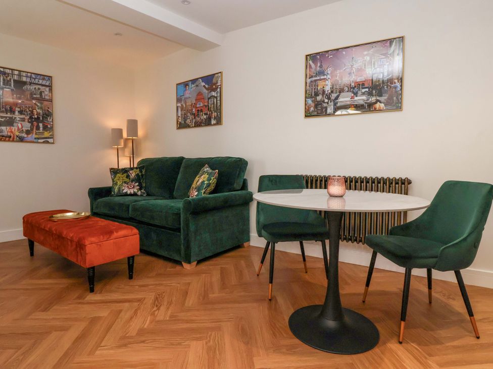 A living room with a sofa and table at The Old Bakehouse in 