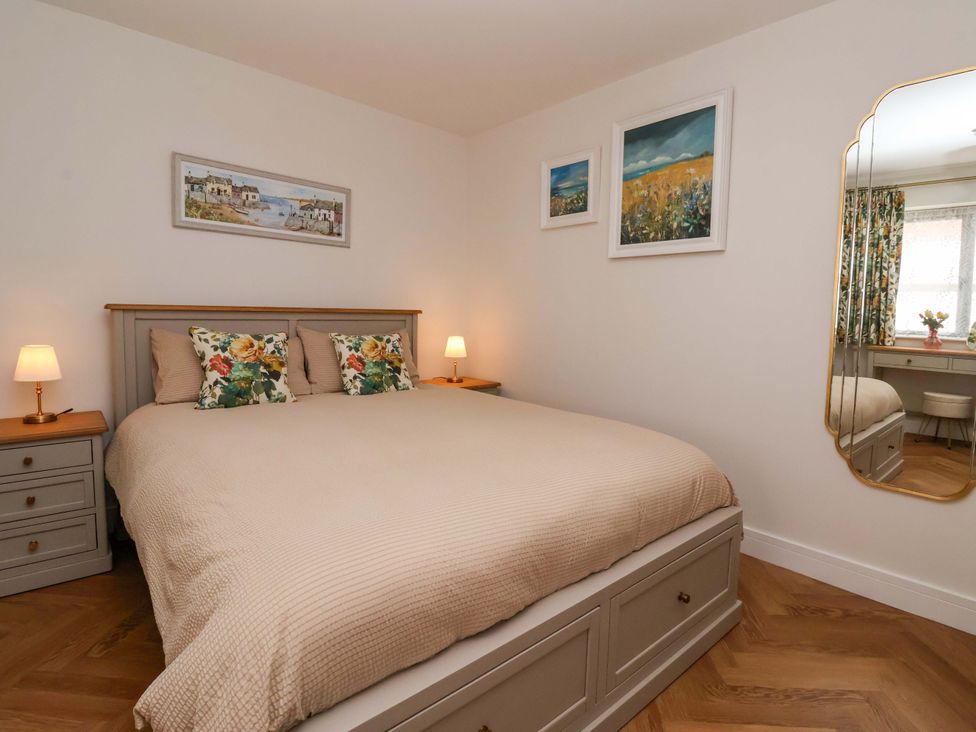 A bedroom with a bed and nightstands at The Old Bakehouse 