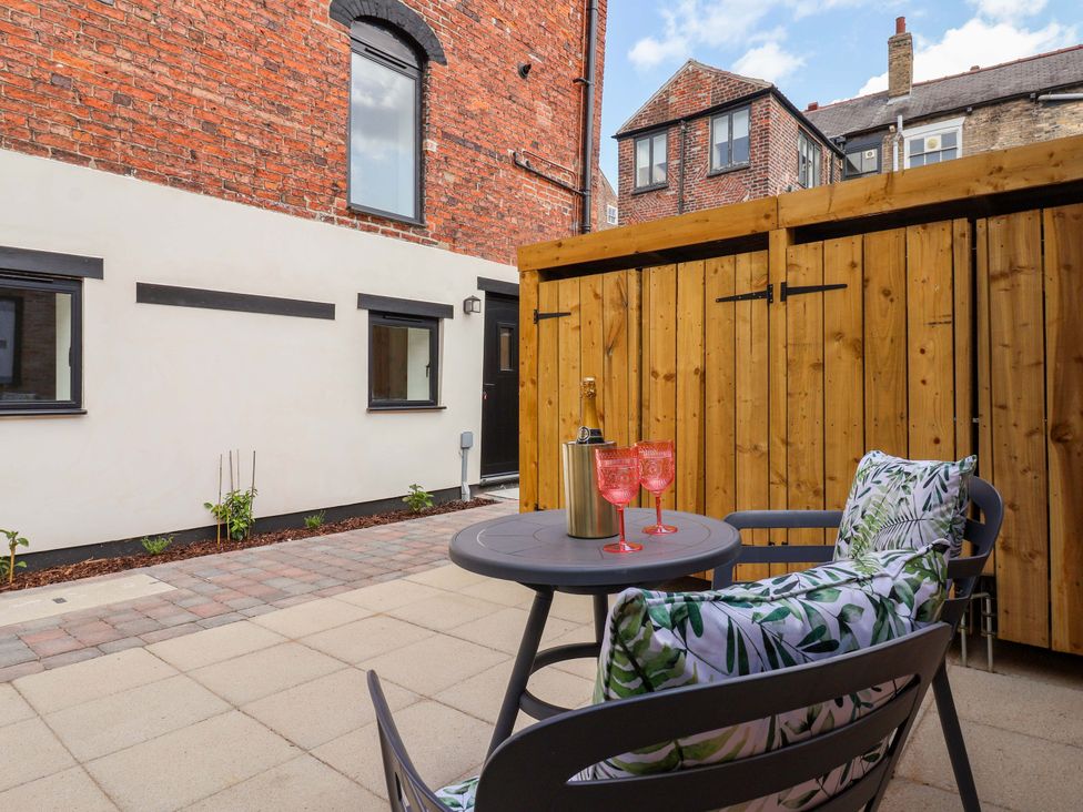 An outdoor space with a table and chairs at The Old Bakehouse
