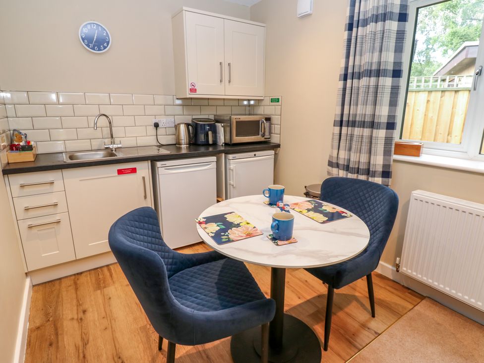 A kitchen with a table and chairs at The Nest in Wetheral