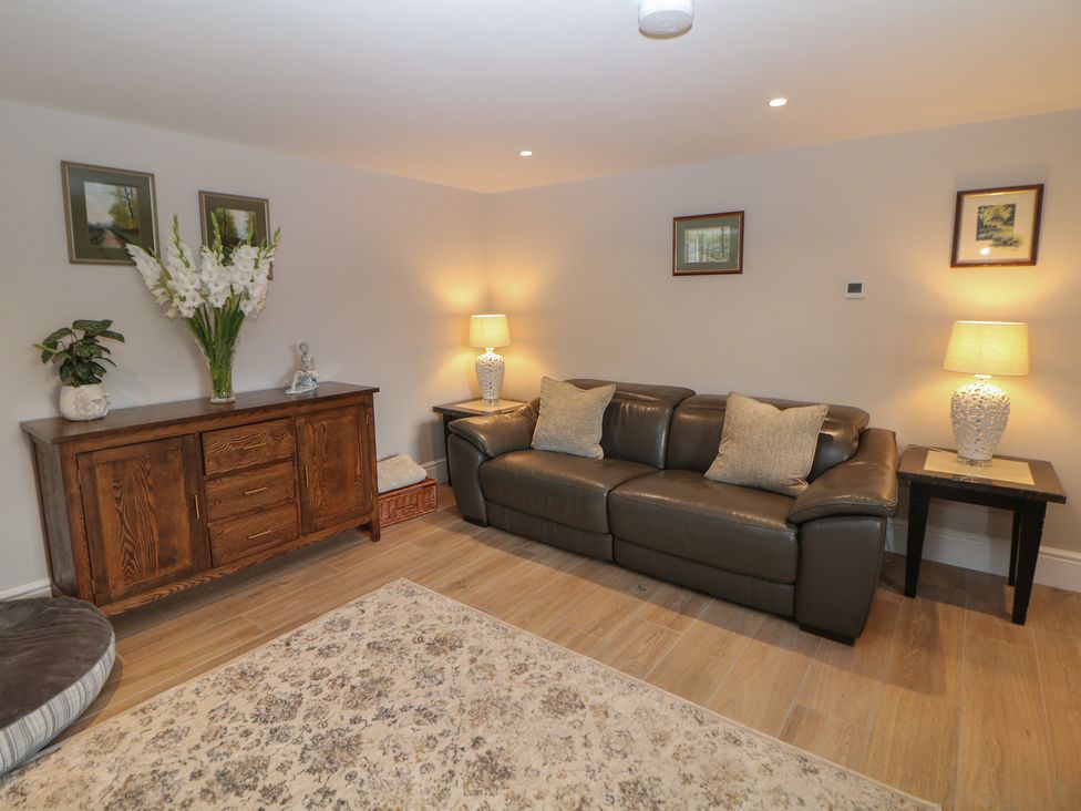 A living room with a couch, lamps and decorative elements at Coach House, Matlock