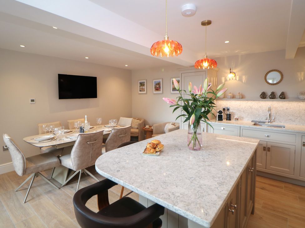 A kitchen with a dining area and an island at Coach House in Matlock