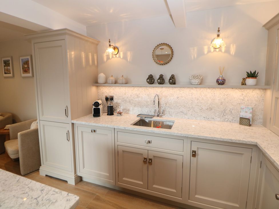 A kitchen with cabinets and a sink at Coach House in Matlock