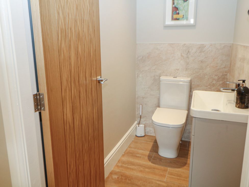 A bathroom with a toilet and sink at Coach House Matlock