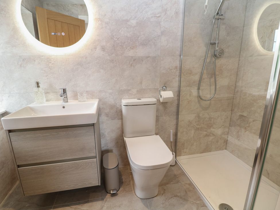 A bathroom with a sink, toilet, and shower at Coach House Matlock
