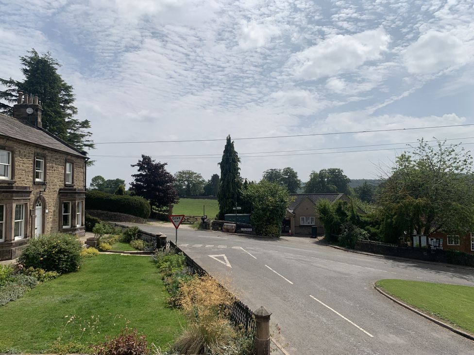 An outdoor area with a house, garden and road at The Coach House Holloway