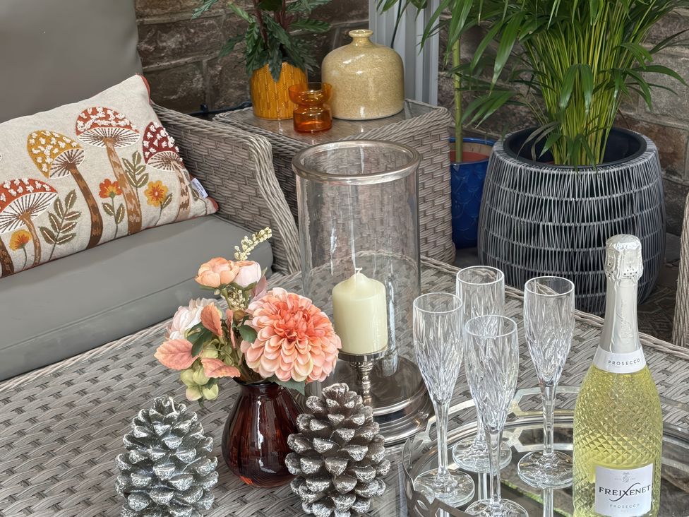 A table with flowers and champagne glasses at The Coach House in Holloway