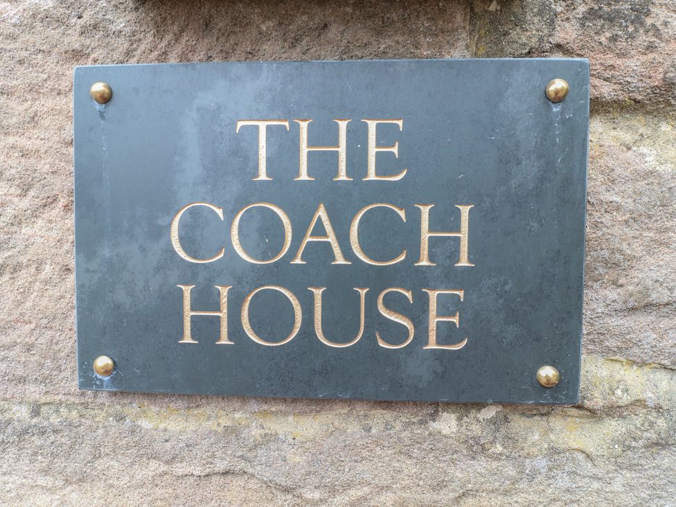A sign reading 'THE COACH HOUSE' at The Coach House in Holloway
