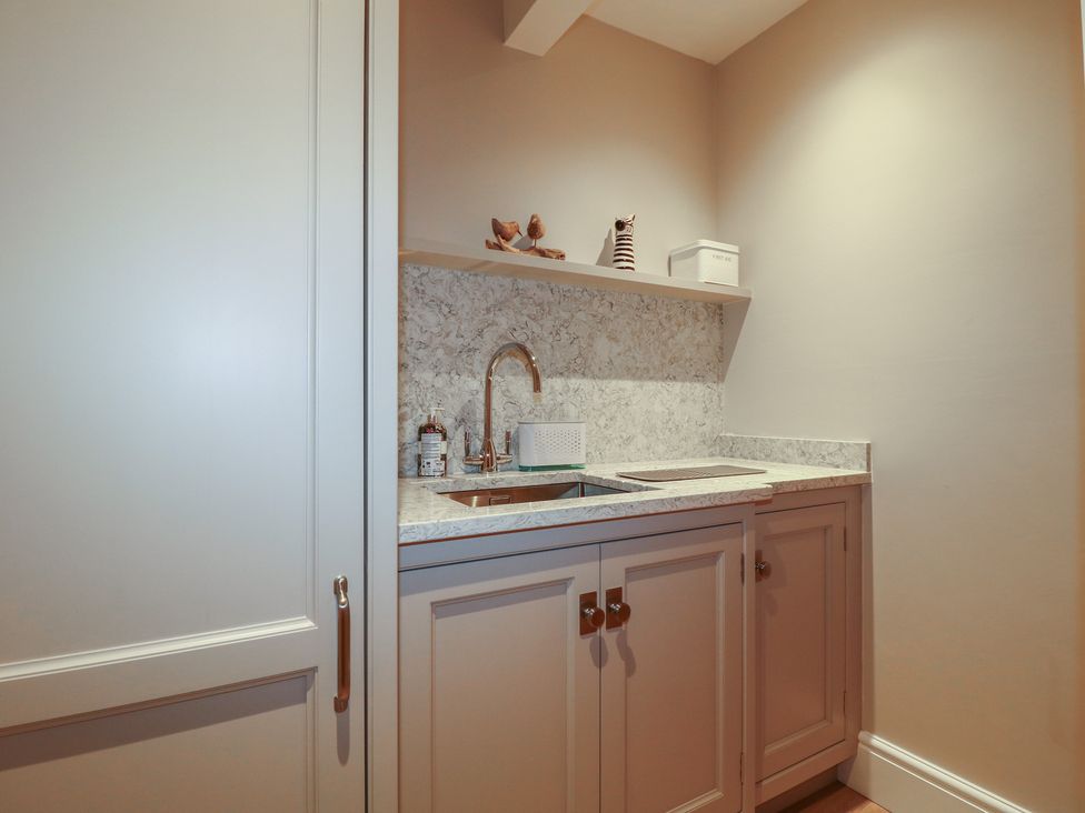A kitchen area with a sink and countertop at The Coach House in Holloway