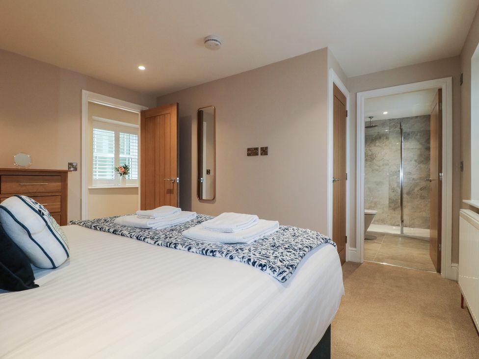 A bedroom featuring a bed and attached bathroom at The Coach House in Holloway