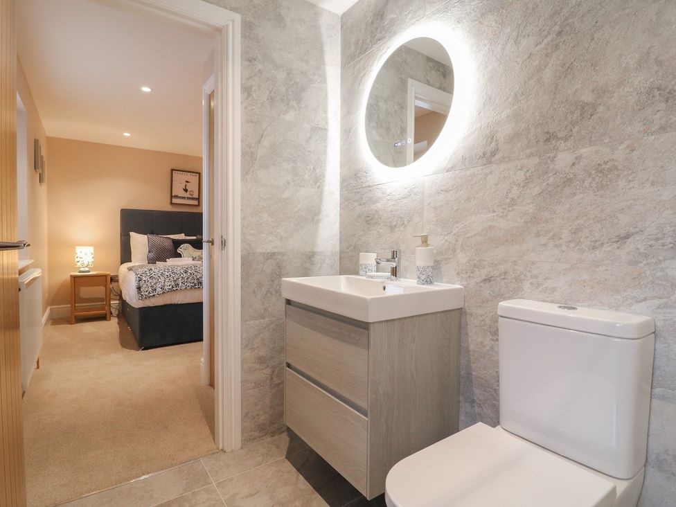 A bathroom with a toilet and vanity unit at The Coach House in Holloway