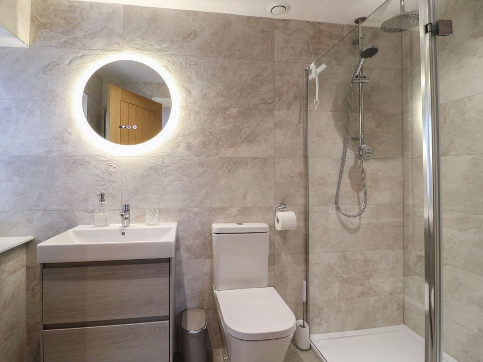 A bathroom featuring a shower and a sink at The Coach House in Holloway