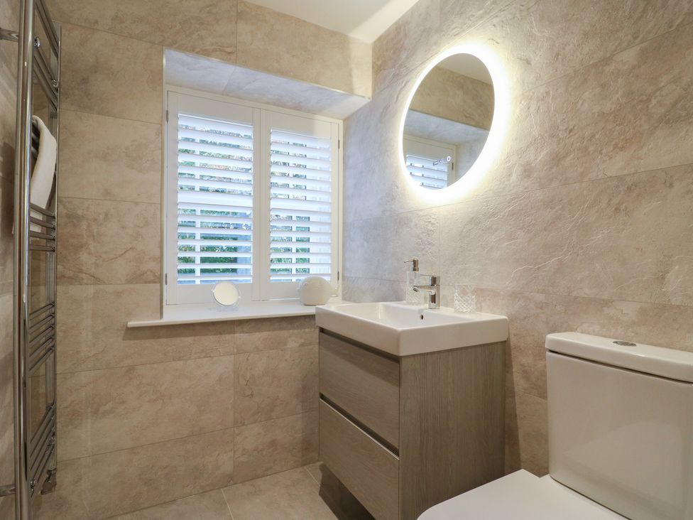 A bathroom with a sink and toilet at The Coach House in Holloway
