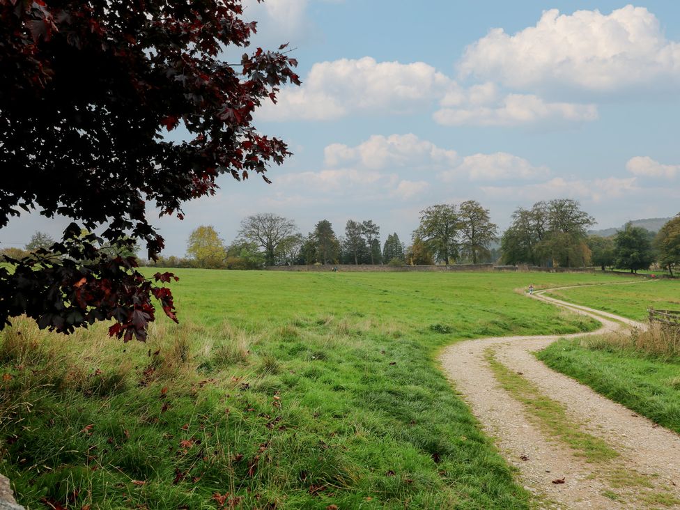 A path through grass with trees in the background at The Coach House in Holloway