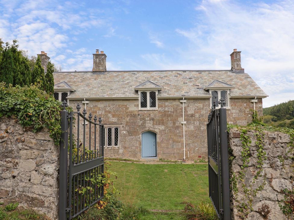 A house with a stone wall and gate at Hole House in Branscombe