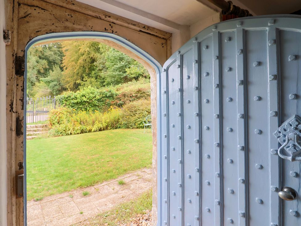 An entrance door leading to a garden area at Hole House in Branscombe