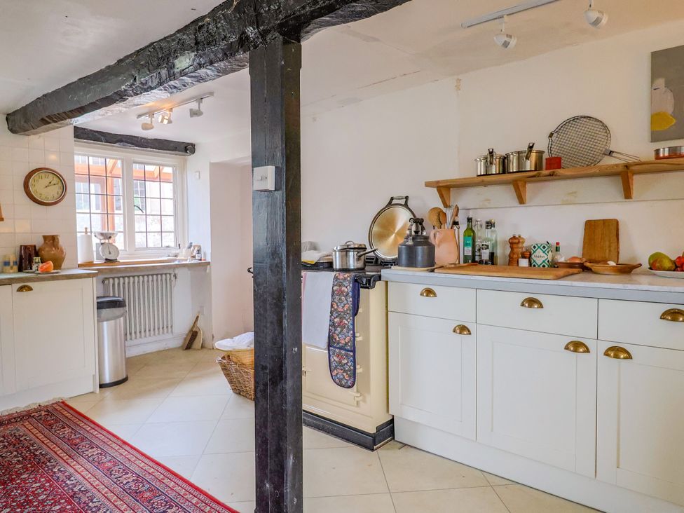 A kitchen with an oven and shelves at Hole House in Branscombe