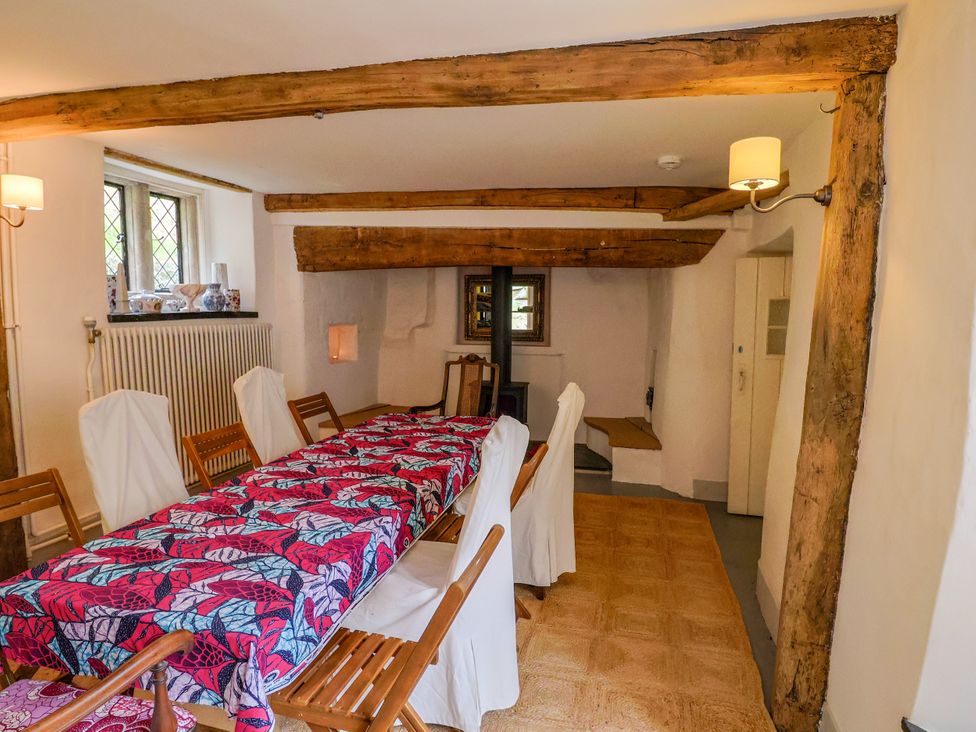 A dining room with a table and chairs at Hole House in Branscombe