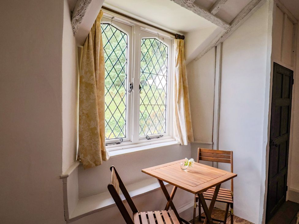 A dining area with a table and chairs at Hole House in Branscombe