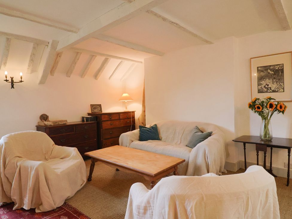 A living room with a sofa and armchairs at Hole House in Branscombe