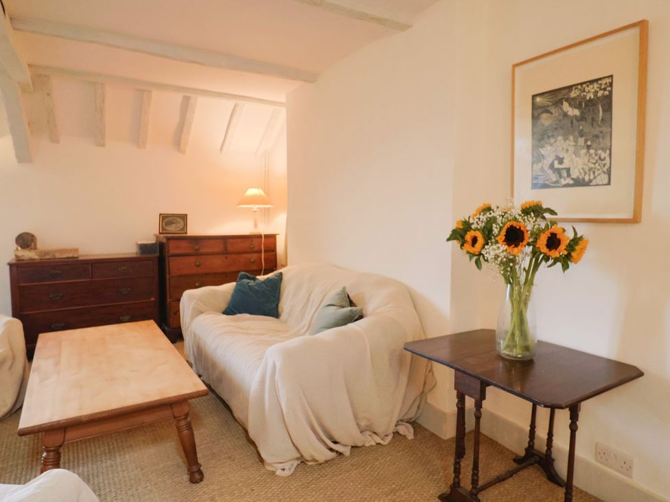A living room with a sofa and coffee table at Hole House in Branscombe