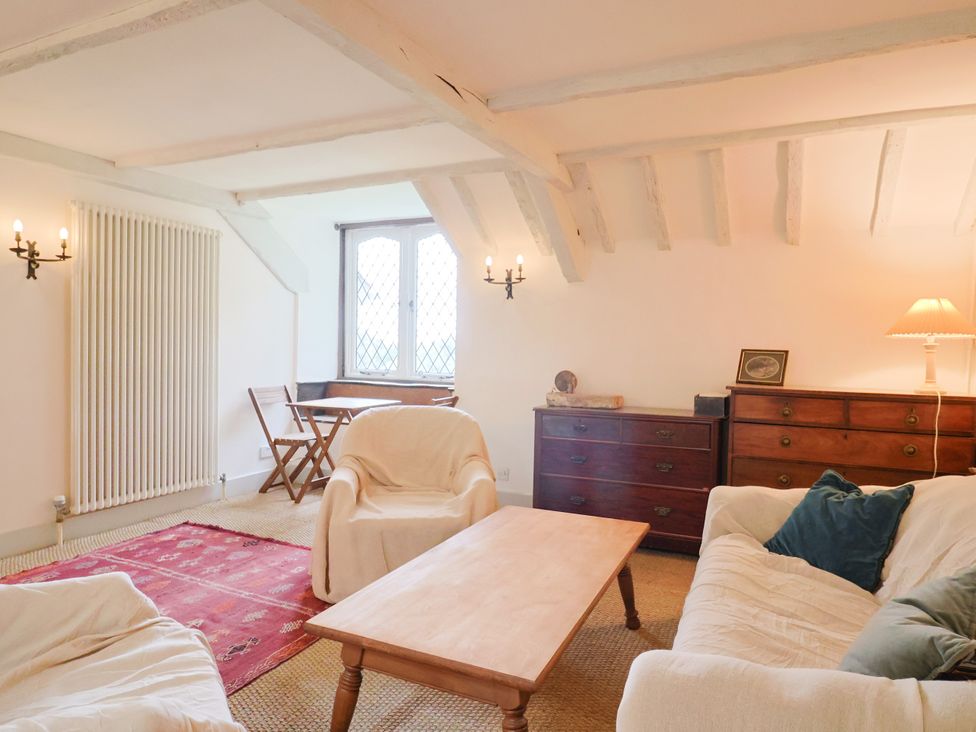 A living room with sofas and a table at Hole House in Branscombe