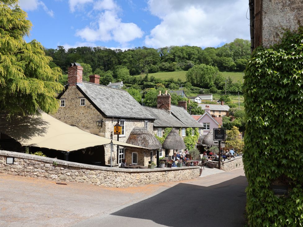 A street with houses and outdoor seating area at Hole House in Branscombe