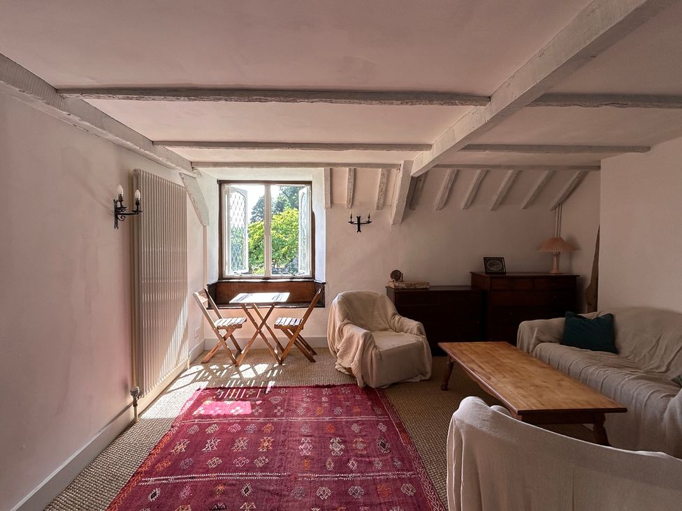 A snug with a table and chairs at Hole House in Branscombe