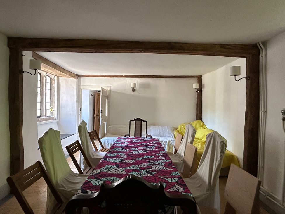 A dining room with a table and chairs at Hole House in Branscombe