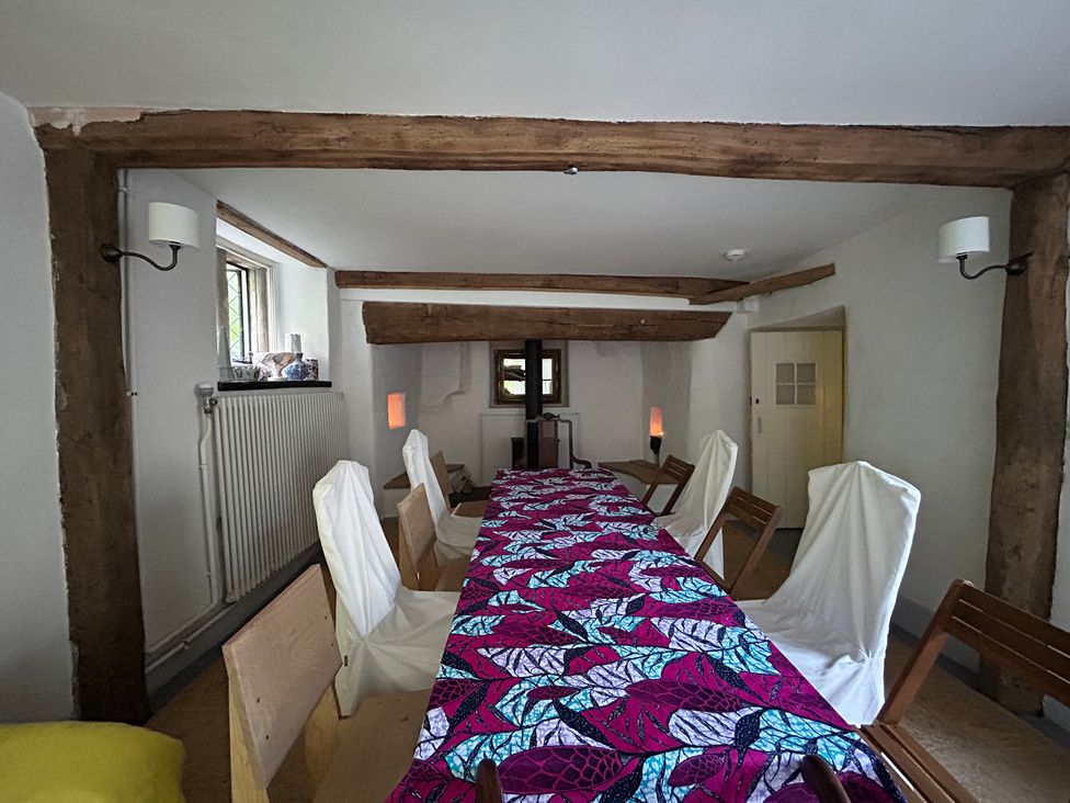 A dining room with a table and chairs at Hole House in Branscombe