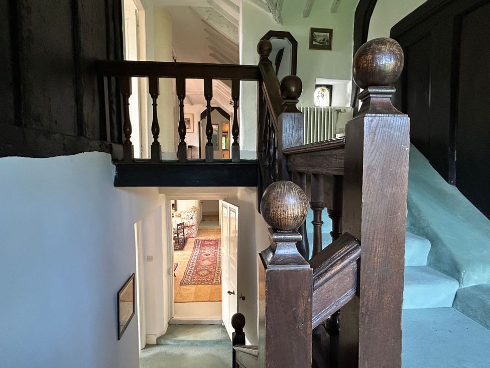 A hallway with a staircase and a doorway at Hole House in Branscombe