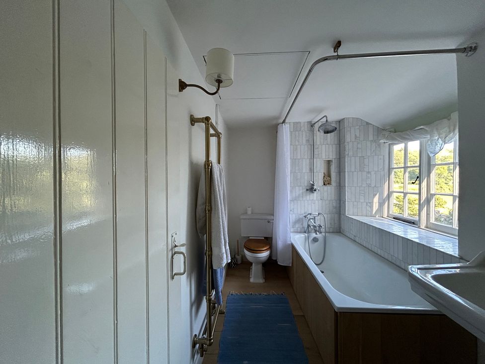 A bathroom with a bathtub and shower at Hole House in Branscombe