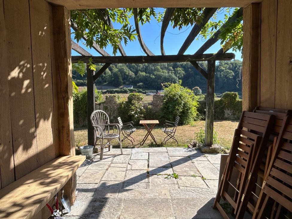 An outdoor patio with a table and chairs at Hole House in Branscombe