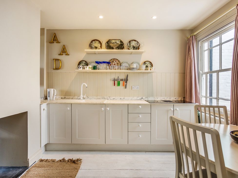 A kitchen with cabinets and a countertop at 8 Mariners Terrace in Chichester