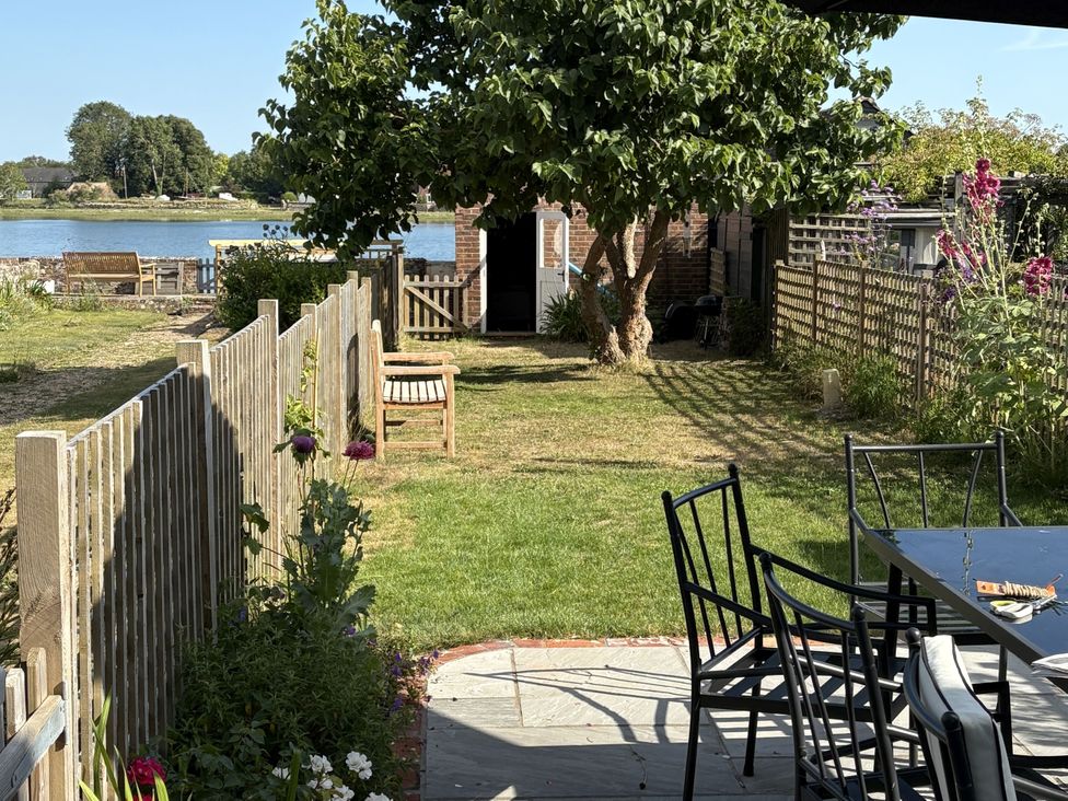 A garden with a table and chairs at 8 Mariners Terrace in Chichester