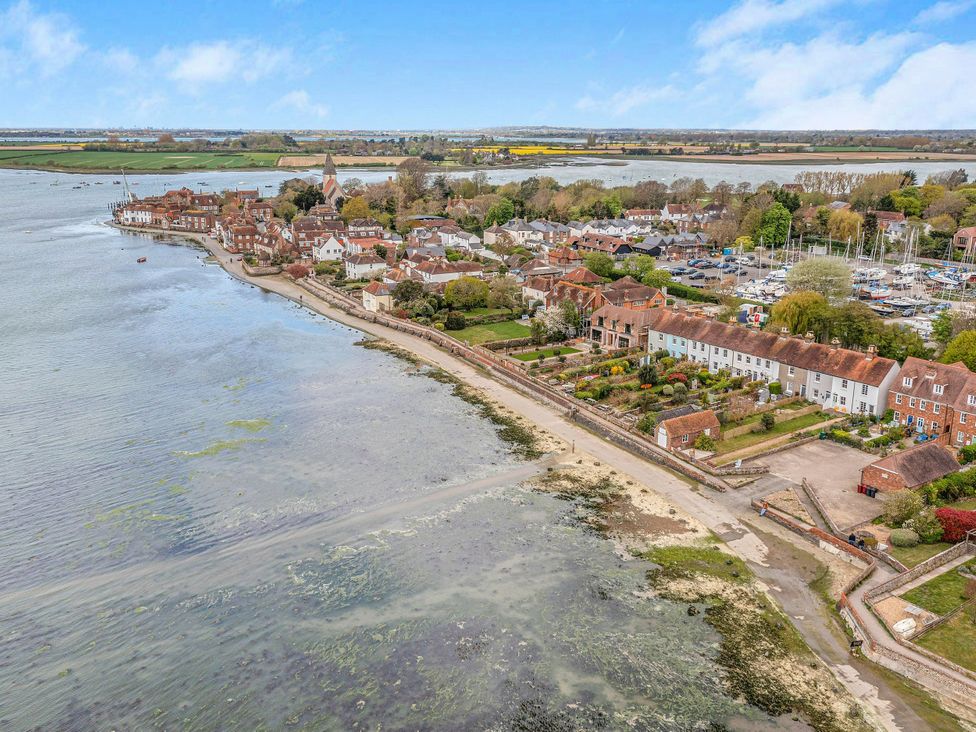 An aerial view of a village by the river at 8 Mariners Terrace, Chichester