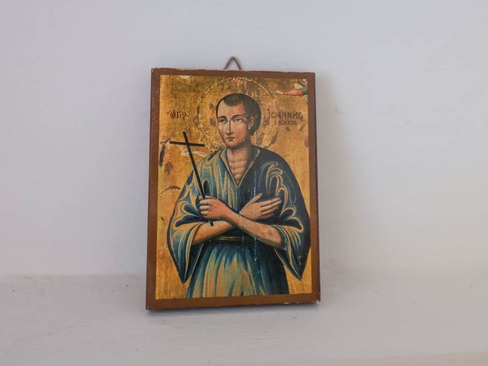 A religious icon painting of a saint holding a cross on a wall at Flat 1 in Scarborough