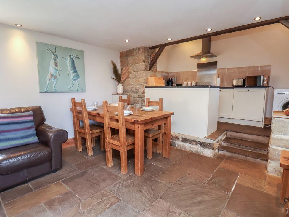 A dining area with a table and chairs at Horseshoe Cottage Ingleby Greenhow near Great Ayton